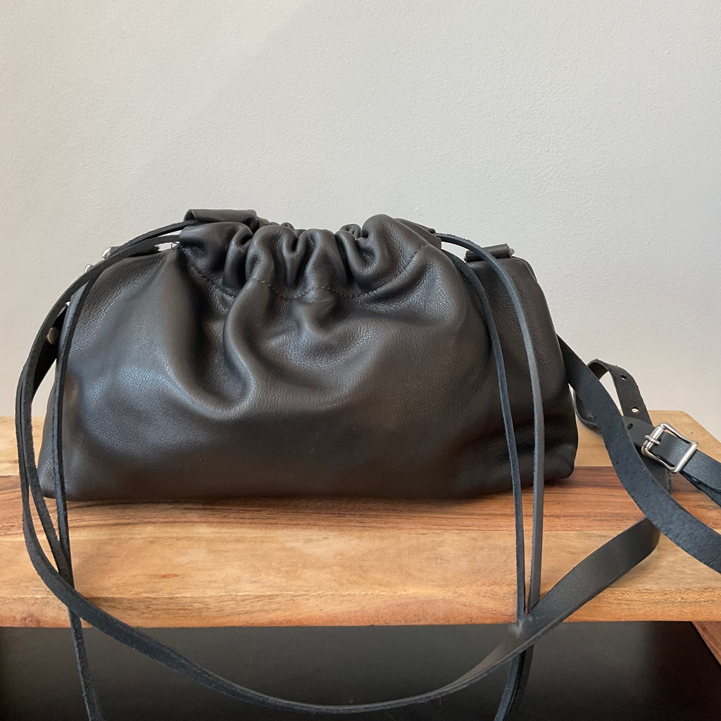 black leather bag on bench