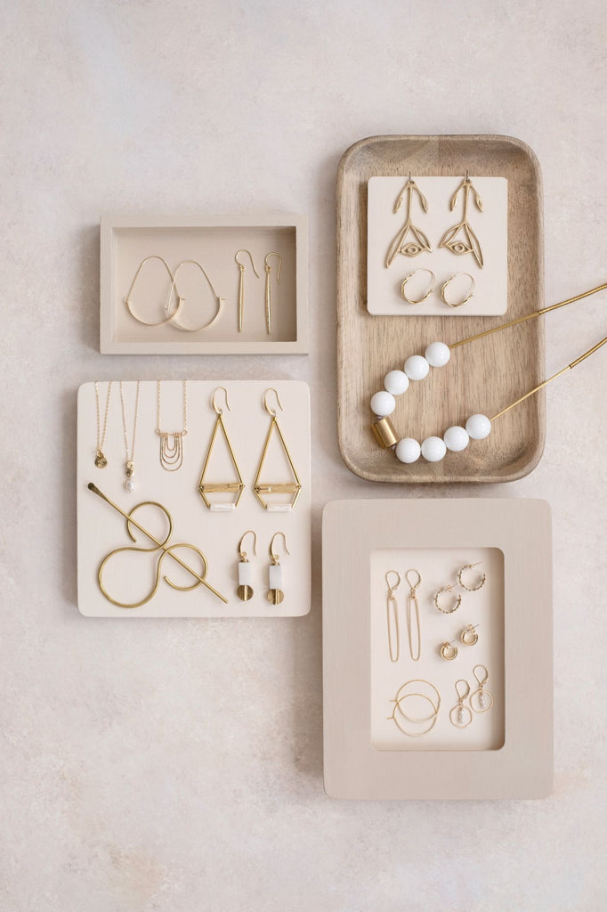 a selection of black, grey and brass jewelry