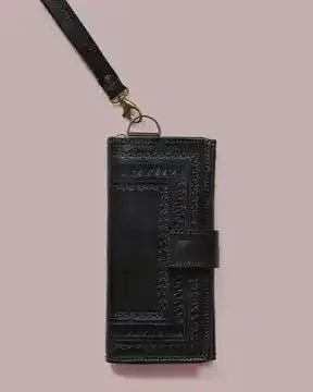 Black embossed phone wallet with lanyard on a pink background