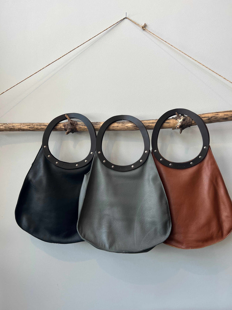 Three handmade leather teardrop handbags