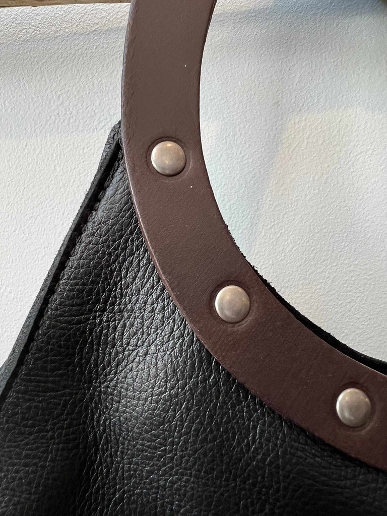 Latigo leather handle detail on teardrop handbag