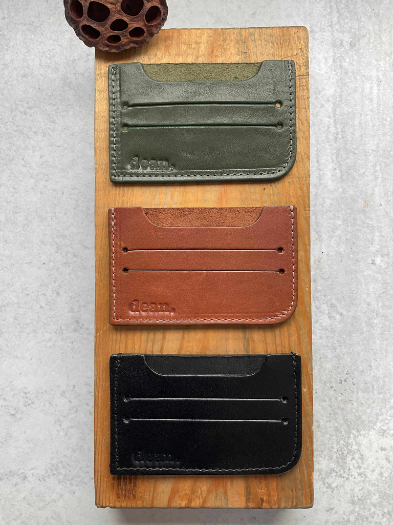 Leather card holders in hunter green, cognac, and black
