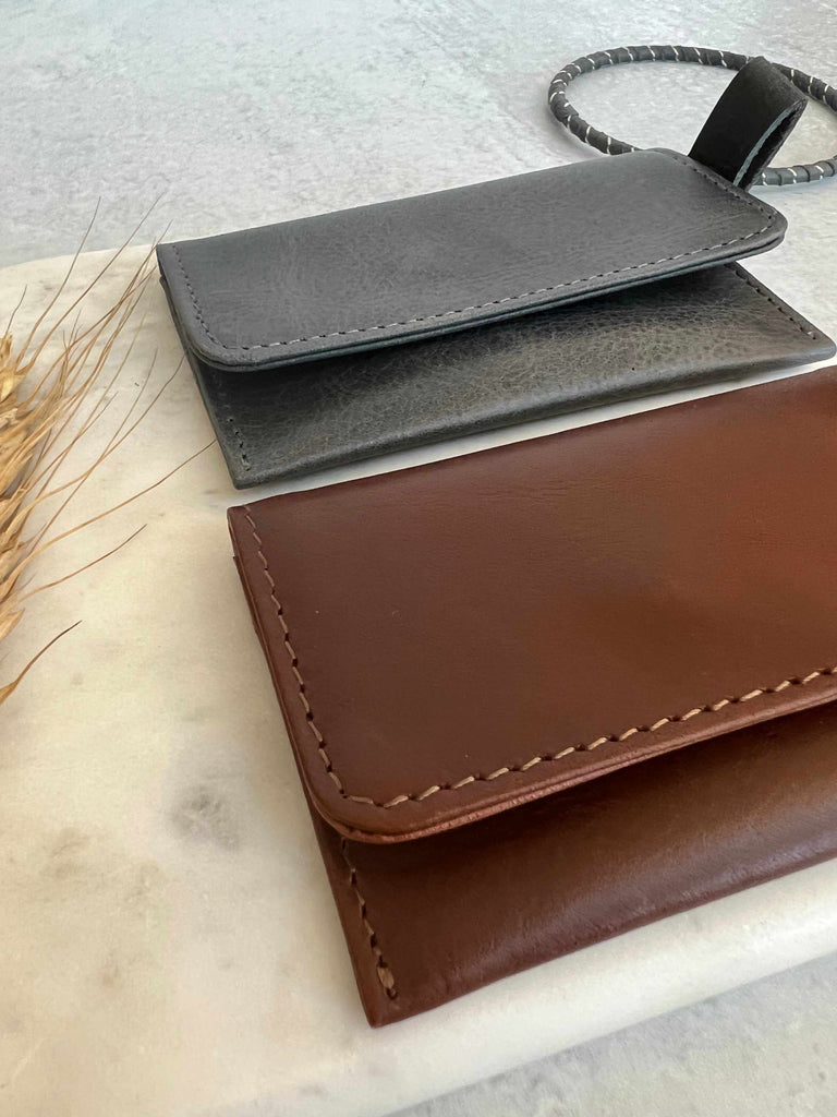 Stitching detail on leather card carrier in chestnut brown