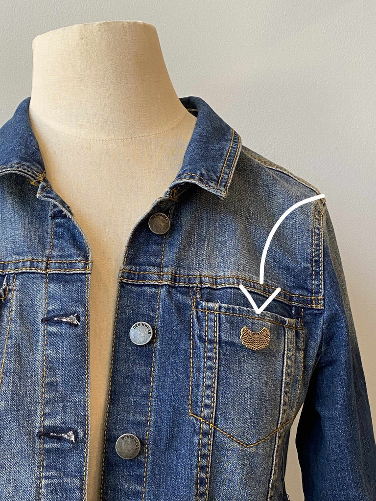 RBG dissent collar pin on denim jacket