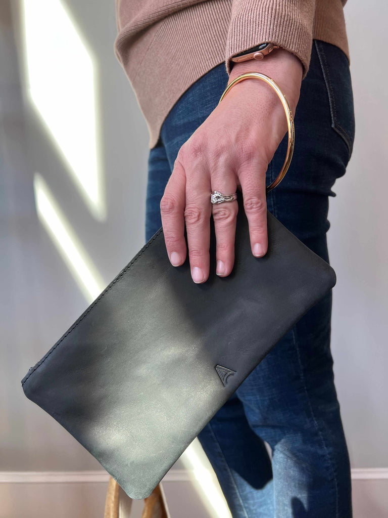 Woman carrying Able Fozi wristlet in black