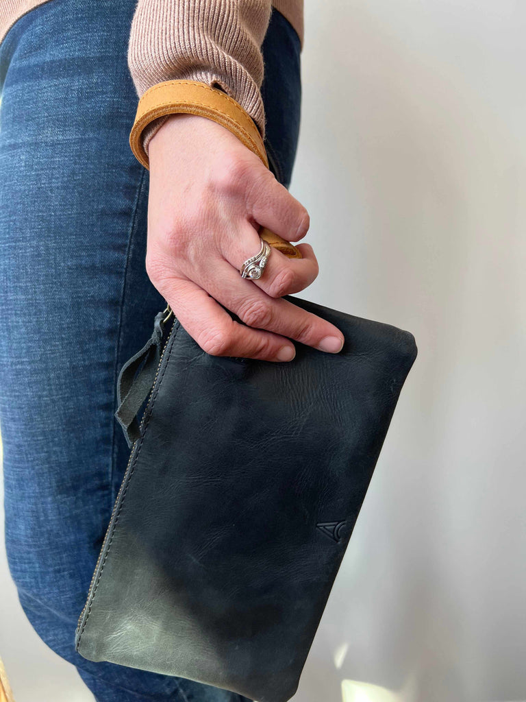 Woman Carrying Rachel Wristlet with Cognac Wrist Strap