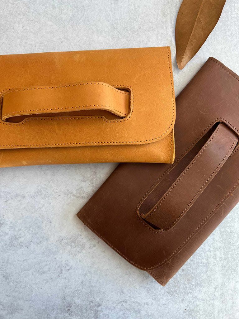Leather Mare handle clutches in cognac and whisky