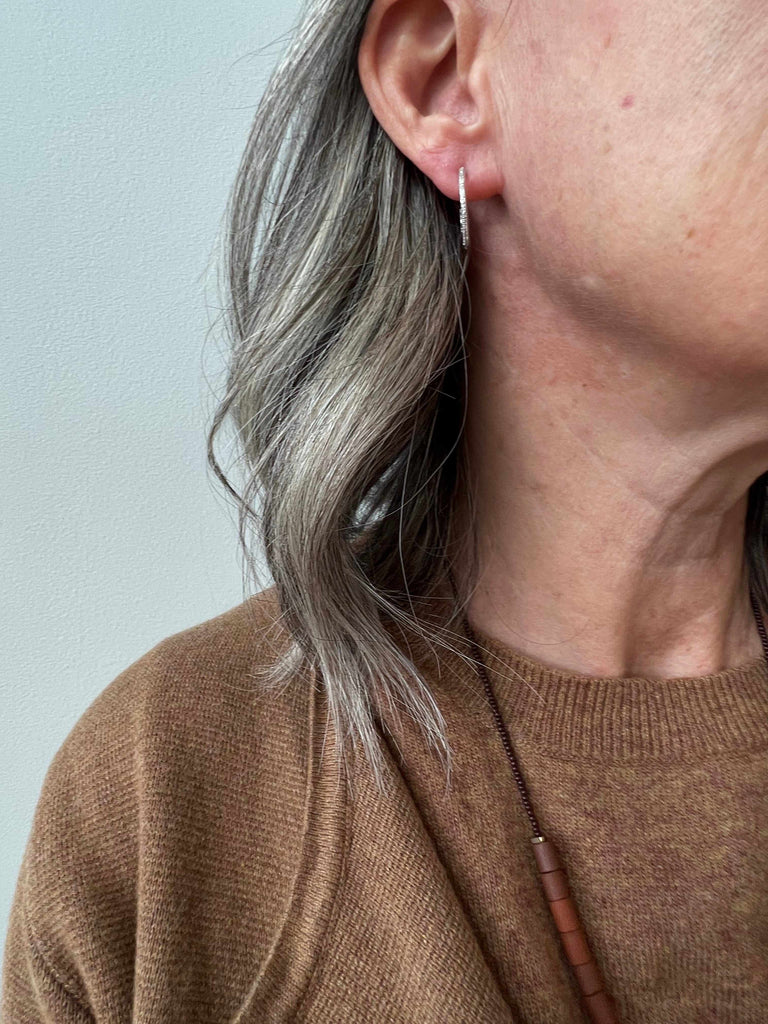 Woman Wearing Small Diamond Hoops