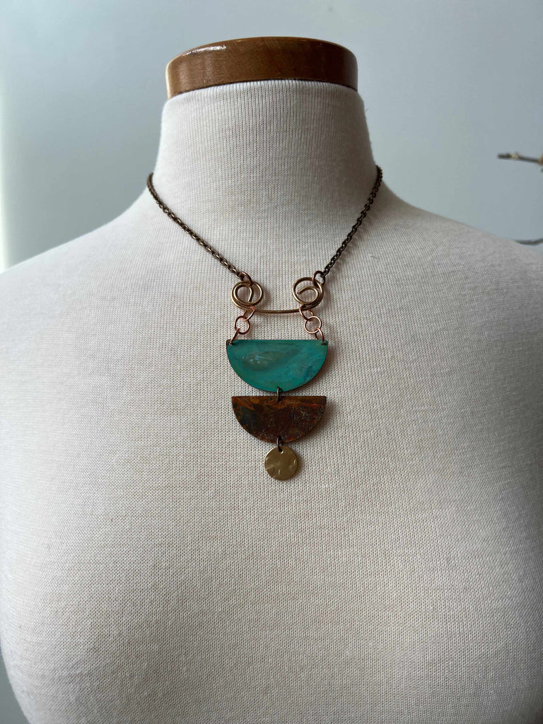Statement necklace in copper and brass on mannequin
