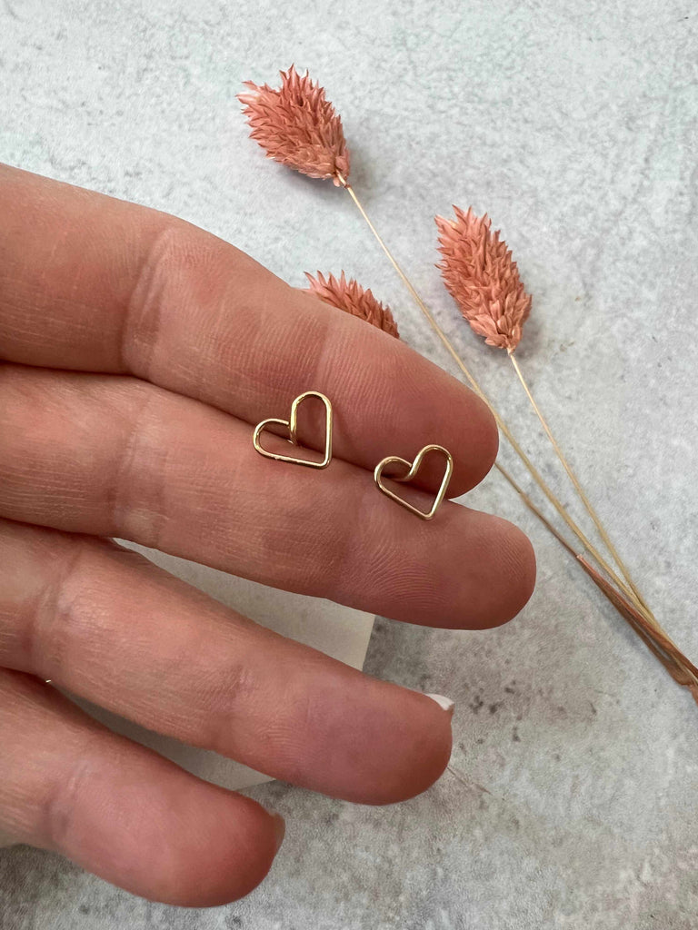Person Holding Open Heart Stud Earrings in Gold Fill