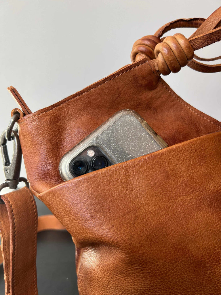Phone pocket on Latico leather Nash crossbody bag in cognac