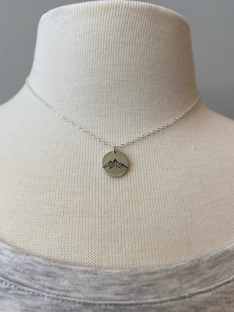Mountain Range Disc Necklace in sterling silver on mannequin