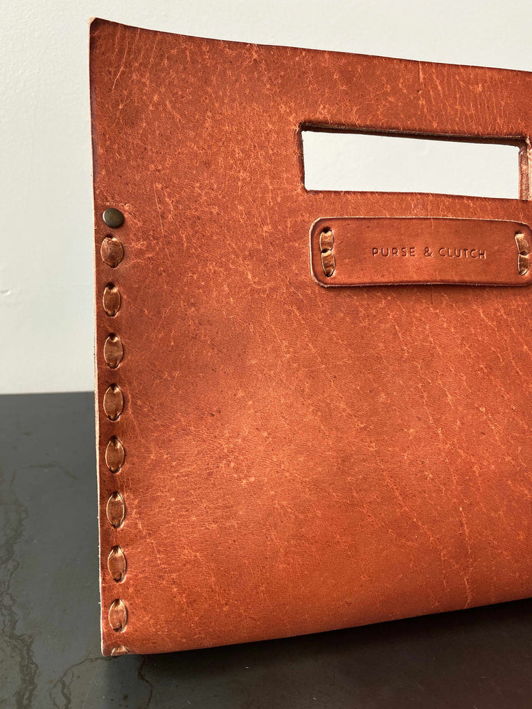 Stitching detail on Everyday clutch in whisky