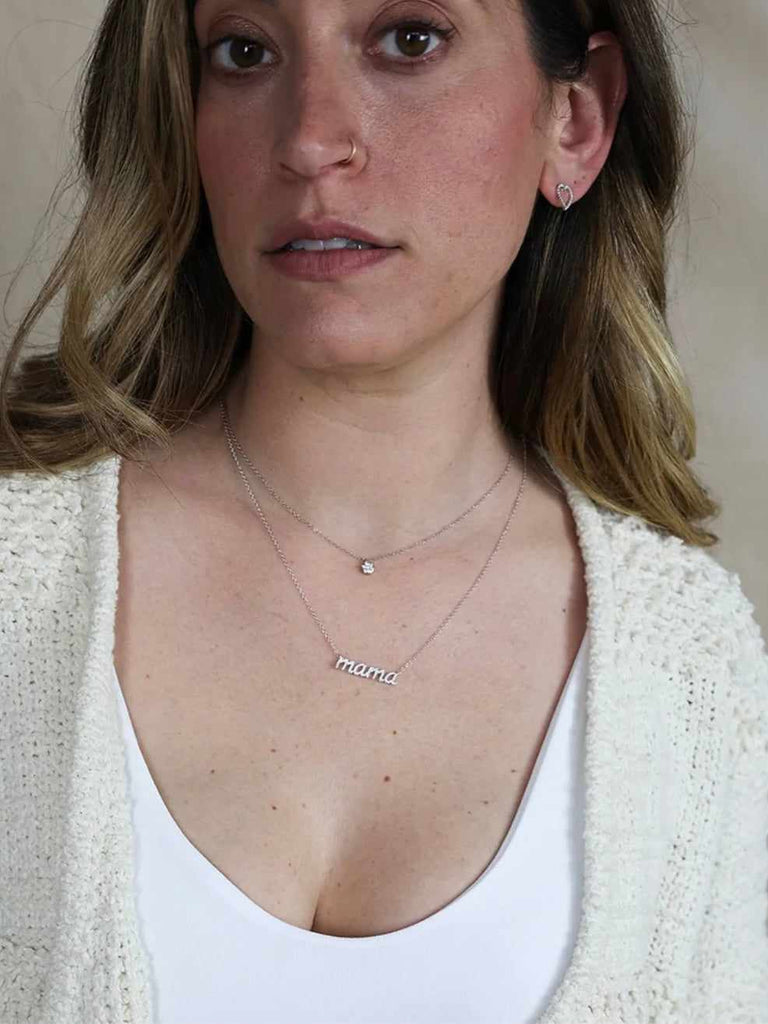Woman wearing Ella Stein diamond mama necklace in sterling silver
