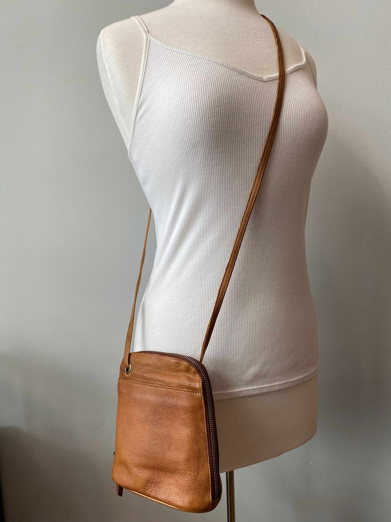 Latico leather small Lilly crossbody bag in cognac on mannequin