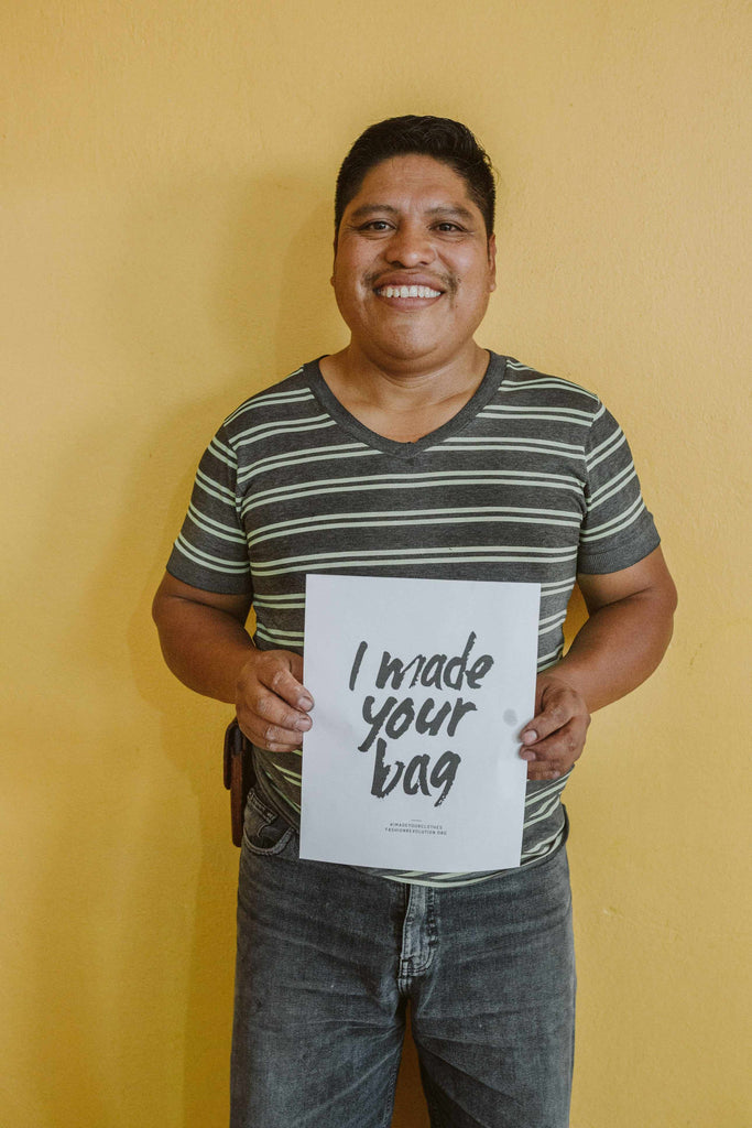 Artisan with "I made your bag" sign