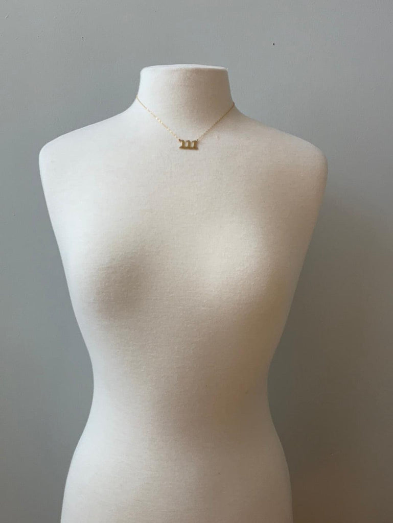 Gold filled angel number necklace on mannequin