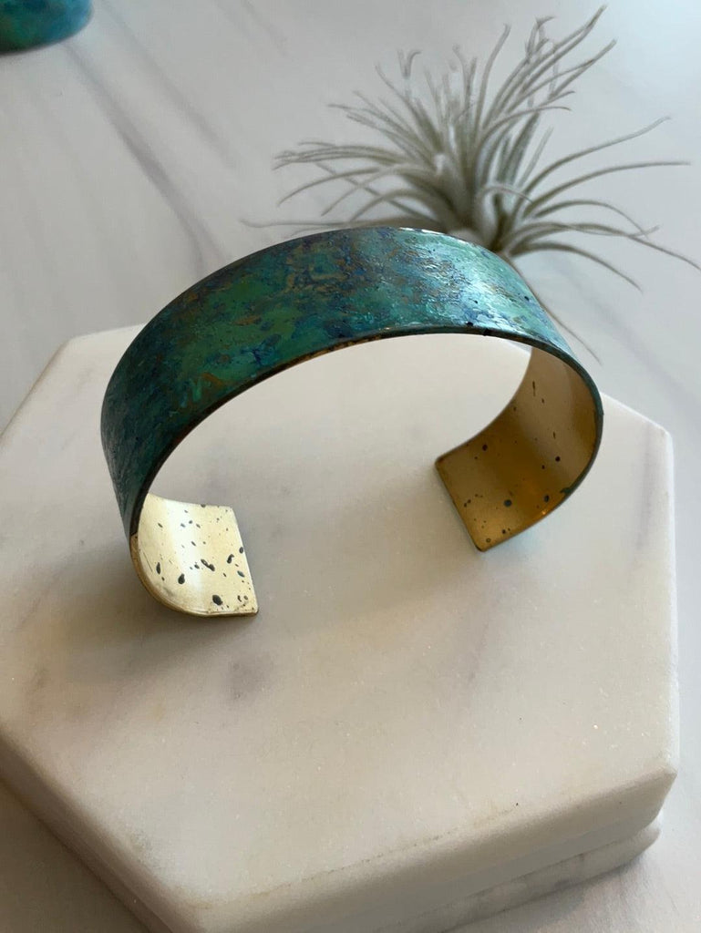 Side of Thin Sea Foam Patina Cuff in unique patina in shades of green, blue, & purple