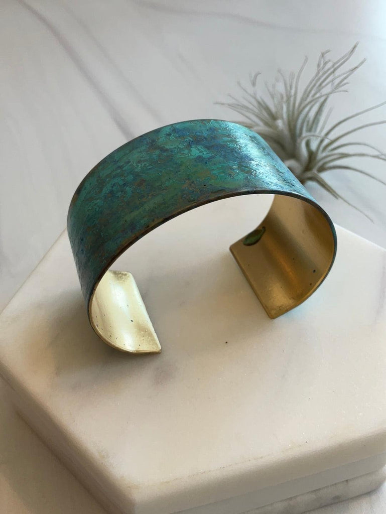 Side of Thick Sea Foam Patina Cuff in unique patina in shades of green, blue, & purple