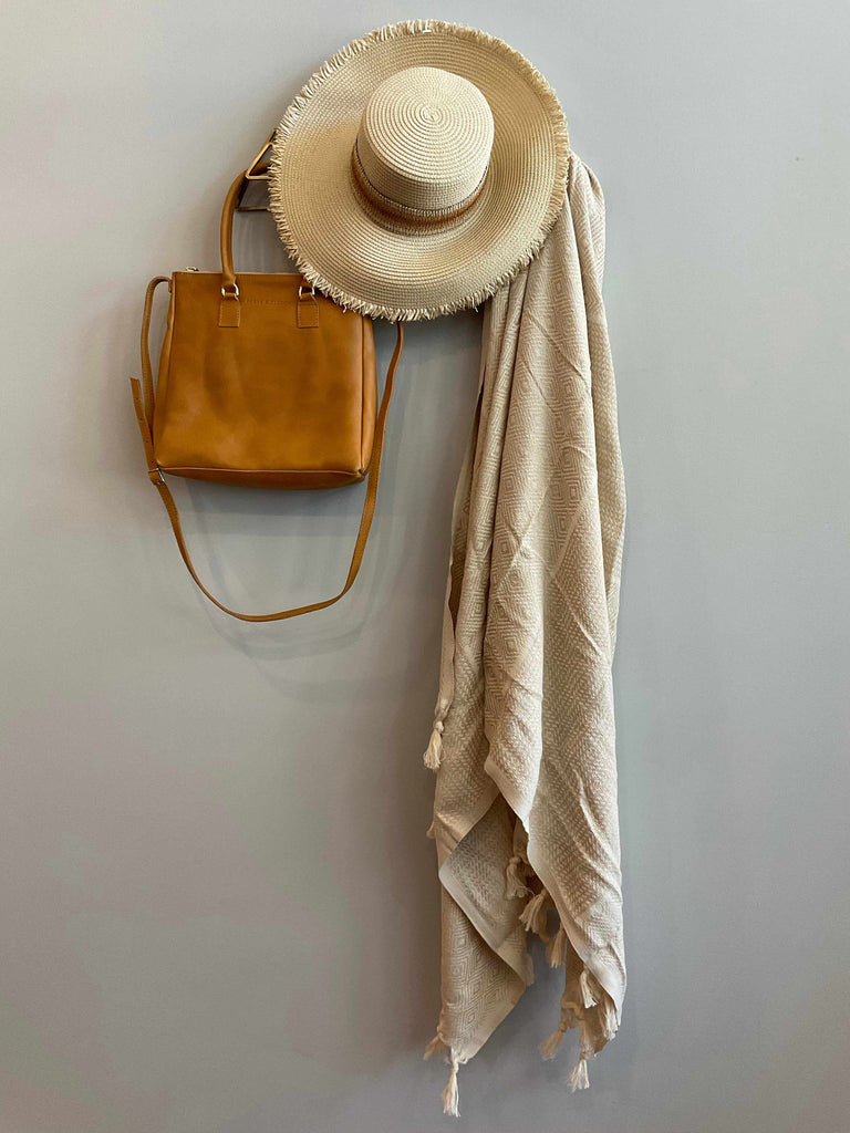 Balina towel, scarf, wrap, or throw in tan and styled with hat and bag
