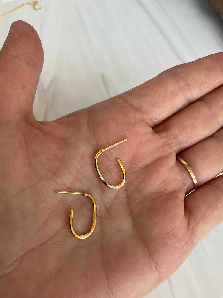 Hand Holding Gold Plated Sterling Mini Hammered Oval Hoop Earrings