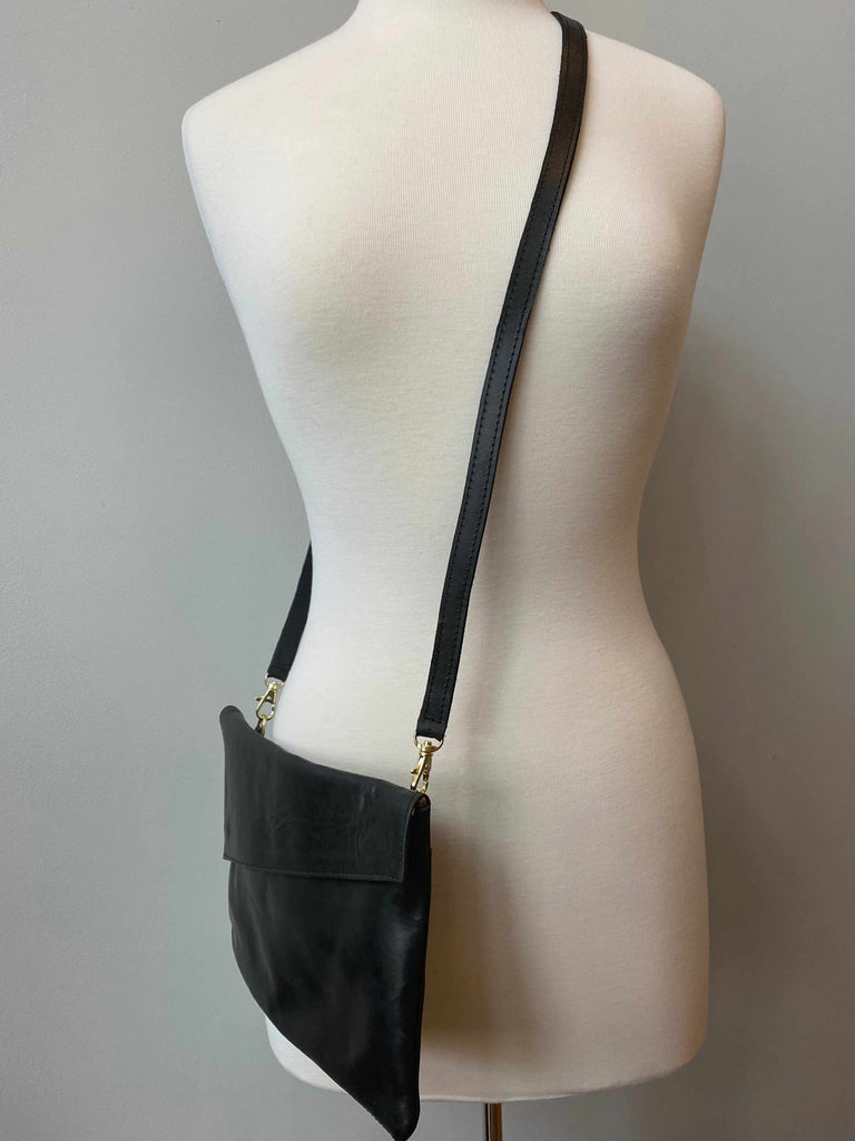 Black convertible crossbody and clutch bag on mannequin