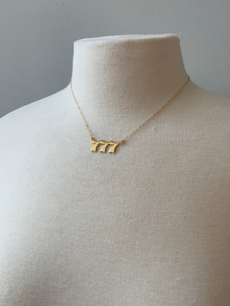 777 Angel number necklace on mannequin