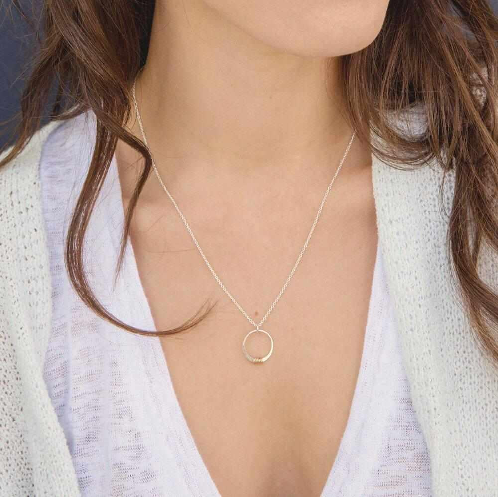 Woman wearing sparkly stitches necklace